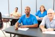 Diverse adult education or college class. Wide angle banner.
